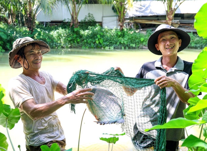 Ông Nguyễn Nhẫn (bên trái ảnh)