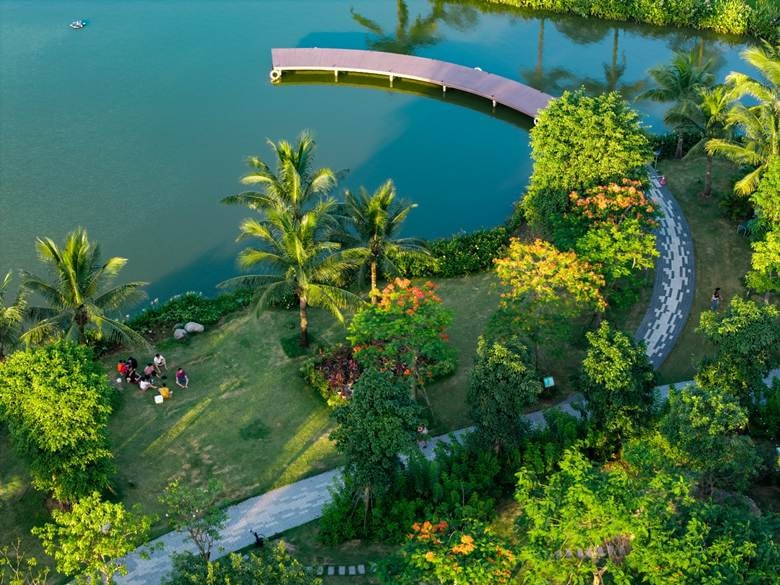A body of water with a path and a bridge Description automatically generated