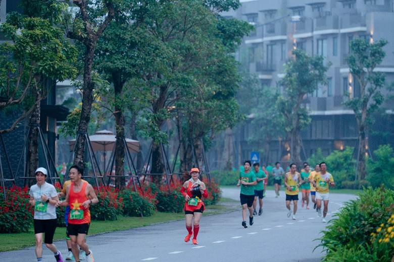 A group of people running on a road Description automatically generated